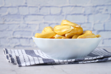 slice of jackfruits in a bowl on table.