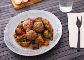 baked meatballs with stewed eggplant, zucchini, green peppers and tomatoes with haze in bowl