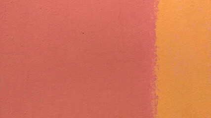 Background from a fragment of a wall of pink and yellow colors with stains. Yellow occupies one third on the right. The texture is rough uneven. Copy space. 
