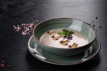 Delicious fresh hot mushroom soup in a ceramic plate.
