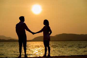 Silhouette young couple at sunset.Valentine's concept.
