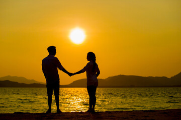 Silhouette young couple at sunset.Valentine's concept.