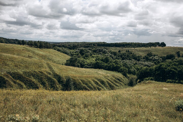 Fototapeta na wymiar Polesie landscape. Green hills and ravines.