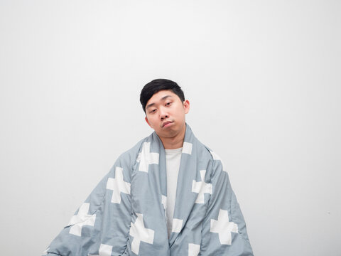 Man cover blacket his body bored face don't want to get work concept on white background space