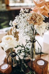 Champagne glasses. Candles and flowers. Banquet table decoration.