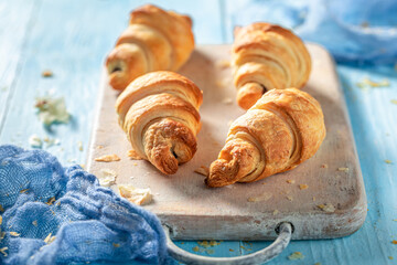 Homemade croissants with melting chocolate. Sweet french dessert.