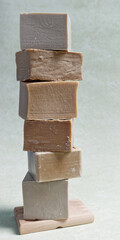 High stack of different similar natural organic soaps. Natural cosmetics stacked in tower.