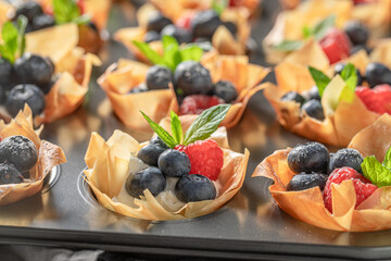 Homemade phyllo cups with berries and cream. Summer snack.