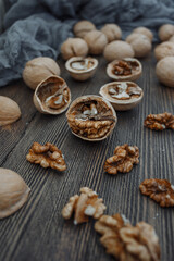 Walnuts lie on a wooden surface. Chopped walnuts on a wooden table top.