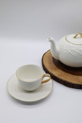 white porcelain teapot and cup