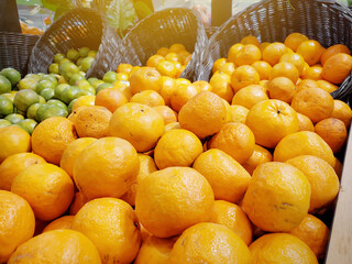 Fresh orange fruit in wooden basket being sold in fruit market