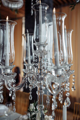 Champagne glasses. Candles and flowers. Banquet table decoration.