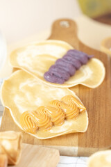 Obraz na płótnie Canvas Crispy crepe roll with fresh sweet cream. Thai dessert call ‘kanhom tokyo’.