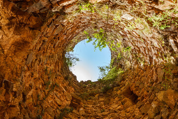 Extreme low angle view inside a ruined keep tower in Castle of Ain, Castellon, Spain. 