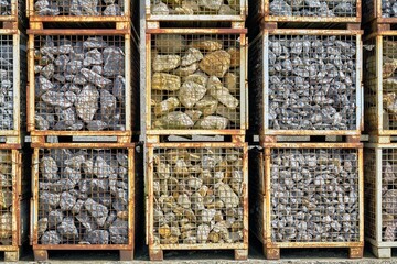 Industrial Stone Storage: Sorted Rock Materials in Metal Grid Containers