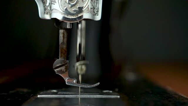 Close up old sewing machine in operation.