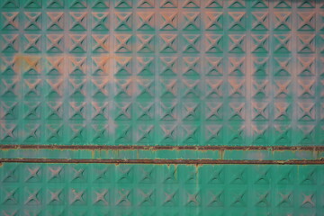 Abstract metal wall with crosses in iridescent colors and two rusty lines