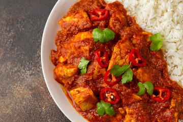 Spicy Chicken Pathia curry with basmati rice in a white plate. healthy food.