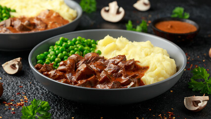 Slow Cooked Steak Diane Casserole with mushroom. mashed potatoes and green peas