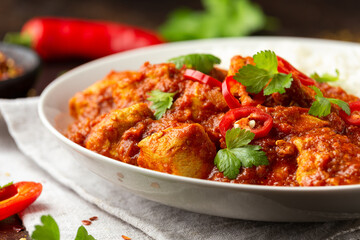 Spicy Chicken Pathia curry with basmati rice in a white plate. healthy food.