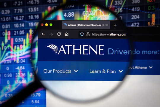 Athene company logo on a website with blurry stock market developments in the background, seen on a computer screen through a magnifying glass