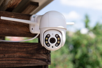 IP CCTV wifi surveillance camera in backyard of house. Home security system concept. blue sky...
