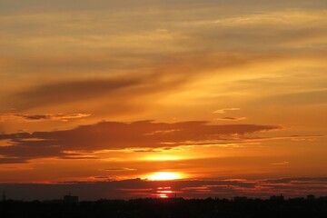 Fototapeta premium Beautiful golden orange sunset background over the city