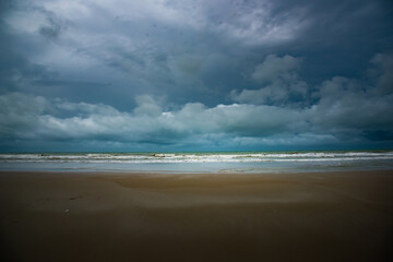 Vintage and retro toning of tropical beach with blue sky and clear sea which including of a wooden umbrella and chair in sunrise time with vintage retro tone. Vacation time as concept.	