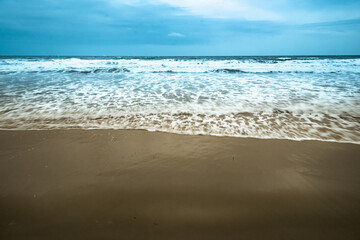 Vintage and retro toning of tropical beach with blue sky and clear sea which including of a wooden umbrella and chair in sunrise time with vintage retro tone. Vacation time as concept.	