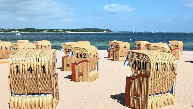 4K 60fps video of beach chairs on white sand beach during sunny weather ot Baltic sea in north Germany