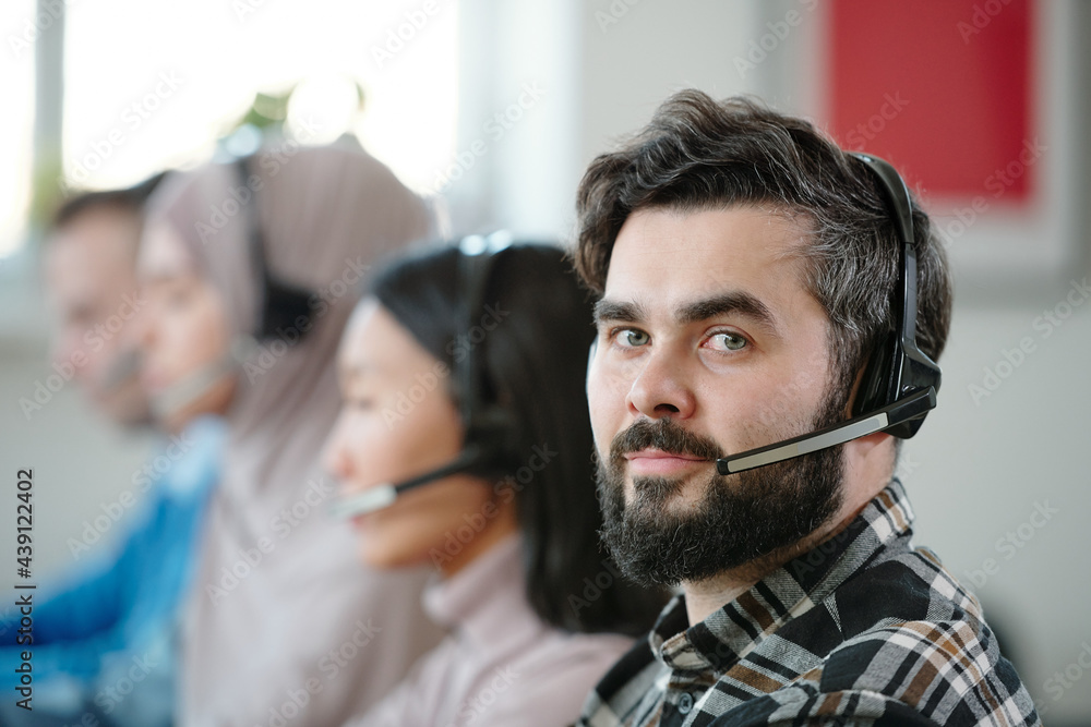 Poster Bearded helpline operator in wireless headset with microphone