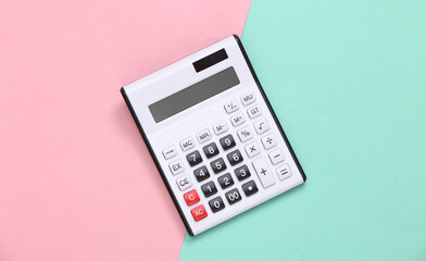 White calculator on pink blue pastel background. Top view. Flat lay