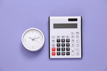 Calculator and clock on purple background. Top view