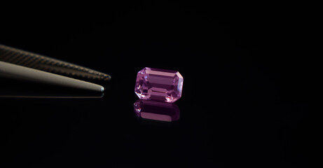 Amethyst is a purple gemstone placed on the ground.