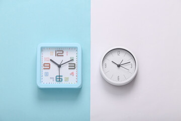 Alarm clocks on white blue background. Top view