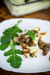 fried toast with cheese spread, arugula and fried mushrooms