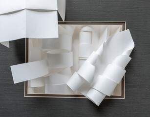 white paper shapes framed by a mat board 