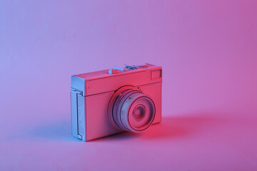 White camera in pink blue gradient neon light. Minimalism