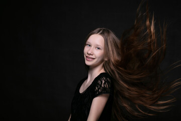 Naklejka premium Portrait of a beautiful teenage girl with fluttering strands of hair.