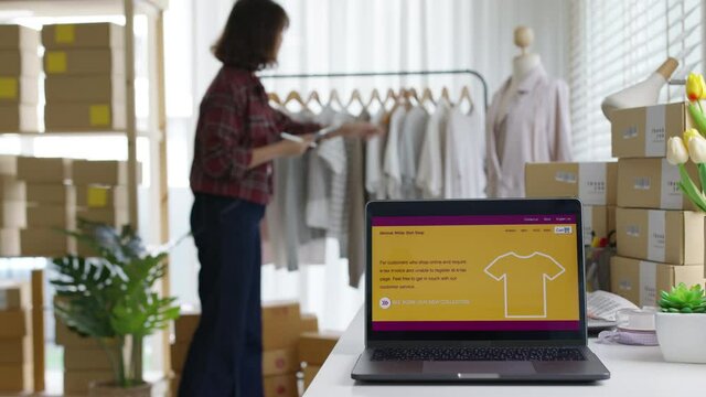 UX UI smart website notebook screen on desk table home office designer studio e-commerce salepage media startup sme with asia busy woman female worker work supply chain logistic delivery wifi network.