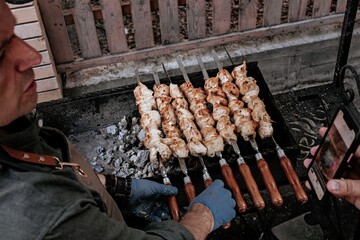 The chef prepares chicken shish kebab and broadcasts to the Internet. Turkish Street food. BBQ...