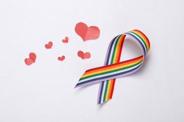 LGBT rainbow ribbon pride tape symbol with hearts on white background. Love concept