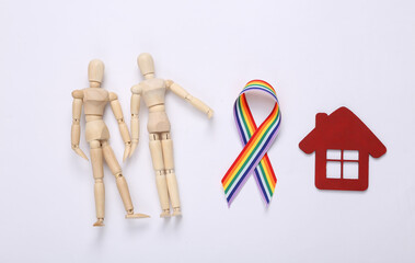 Two puppets hold hands, house and LGBT rainbow ribbon pride tape symbol on white background. Love...