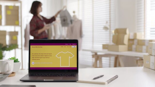 UX UI smart website notebook screen on desk table home office designer studio e-commerce salepage media startup sme with asia busy woman female worker work supply chain logistic delivery wifi network.