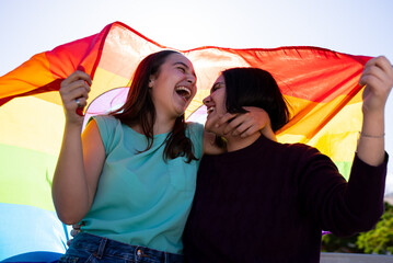 lesbian girls having fun painting themselves and with the lgtb flag on pride day
lgtb concept