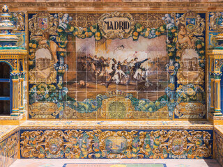 bench in the plaza españa in seville, representing historical events in Madrid in Pisan tiles and with two towers of shelves on the sides.