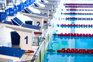 Aligned swimming starting block and platform with number 1
