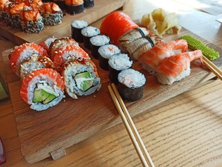 Japanese sushi food. Maki and rolls. Top view of assorted sushi. Serving on a wooden board 