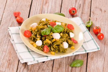Fusilli pasta with cherry tomatoes and sweet corn.