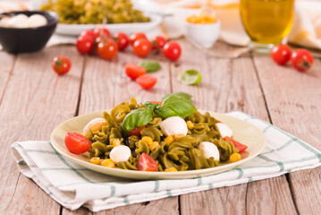 Fusilli pasta with cherry tomatoes and sweet corn.